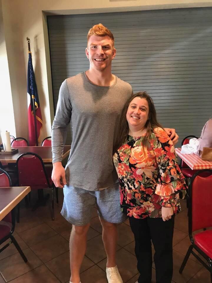 NFL quarterback Andy Dalton, formerly of Katy High School, meets with Special Olympics athlete Shelby Day, of Katy, in this 2020 photo taken at Midway Barbecue .